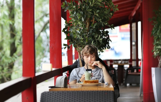 Lifestyle portrait of a young man using a smart phone outdoors