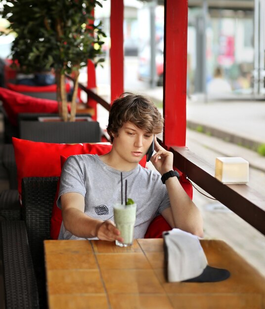 Lifestyle portrait of a young man using a smart phone outdoors