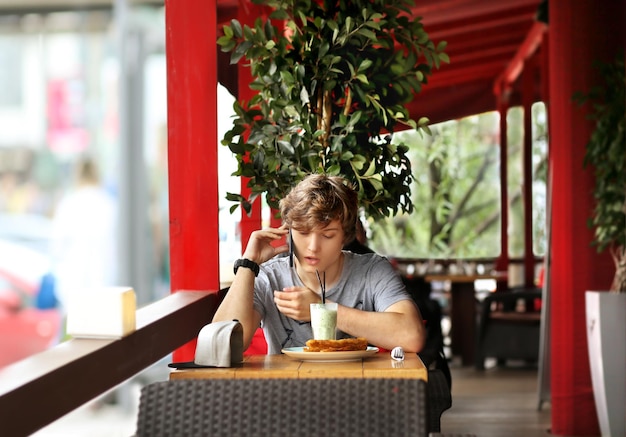 Lifestyle portrait of a young man using a smart phone outdoors