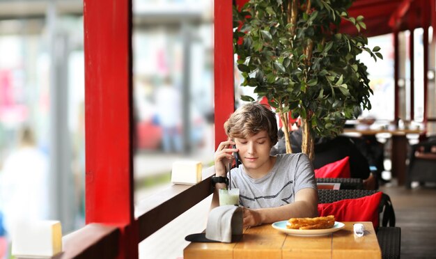 Lifestyle portrait of a young man using a smart phone outdoors