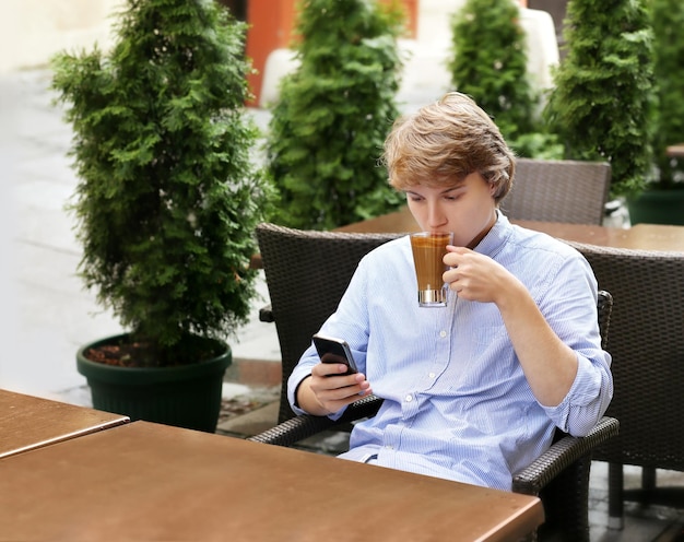 Lifestyle portrait of a young man using a smartphone outdoors