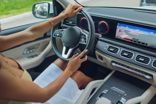 Lifestyle shot of young cheerful woman driving car  rear view