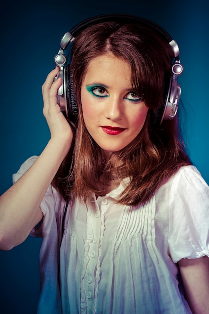 Lifestyle, young girl listening music with huge headphones