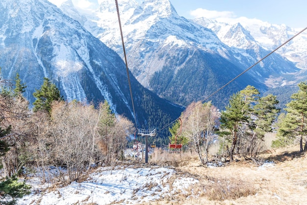 Lifting mechanism and iron lifts in snowy high mountains on a sunny day against a bright blue sky Travel tourism and outdoor activities