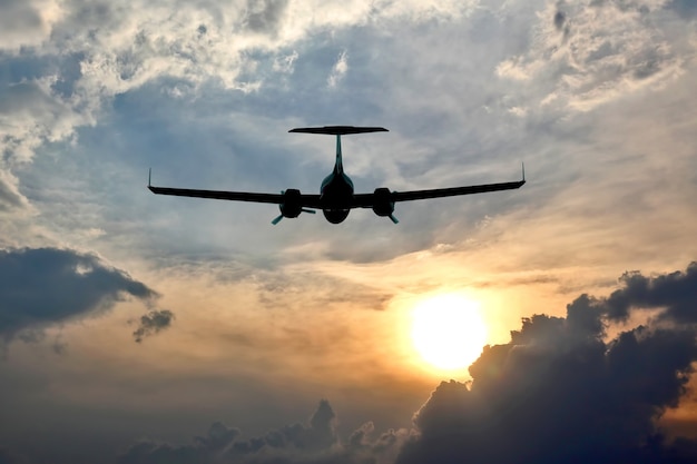 Light aircraft flying in the sky at sunset