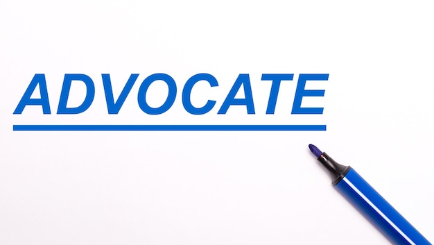 On a light background, an open blue felt-tip pen and the text ADVOCATE