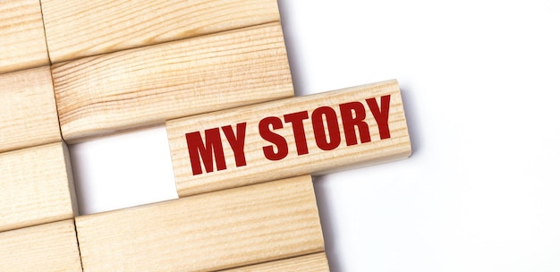 On a light background wooden blocks with the text MY STORY Closeup top view