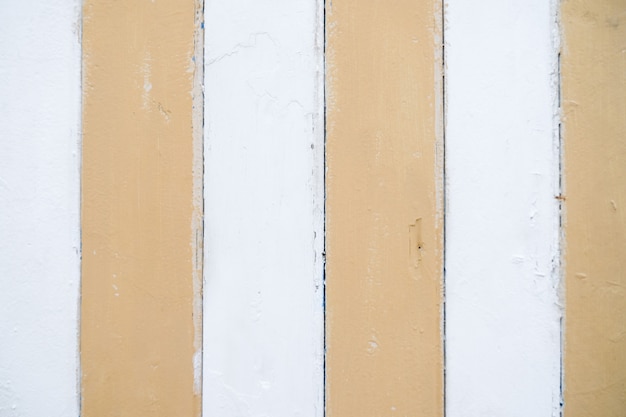 Light background wooden texture. Striped yellow and white paint.