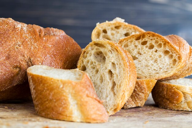 Light baguette of rye flour, close-up of food on the kitchen cutting Board