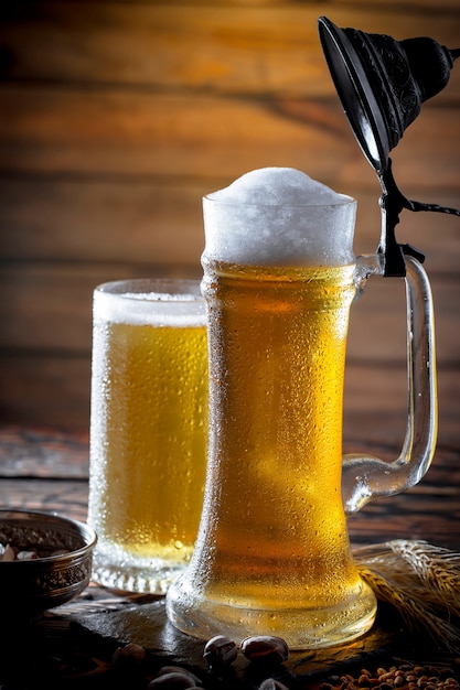 Light beer in a beer glass on an old background.