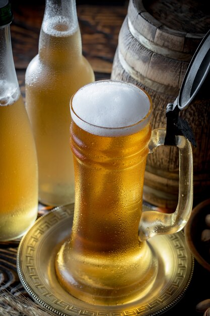 Light beer in a beer glass on an old background.