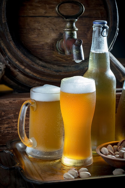 Light beer in a beer glass on an old background.