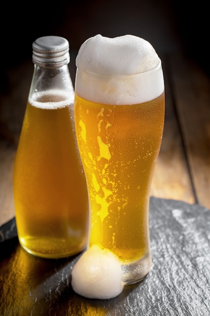 Light beer in a beer glass on an old background.