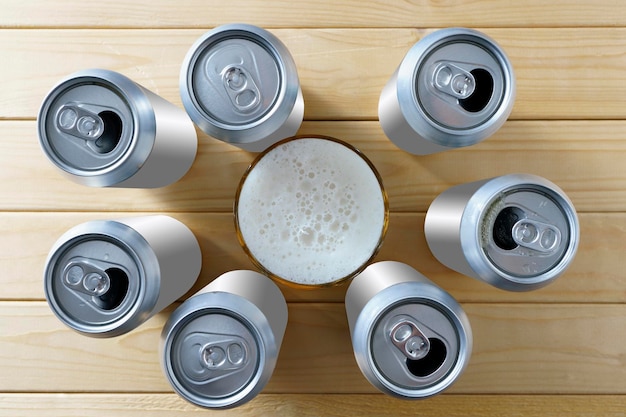 Light beer in cans and in a glass on a wooden background with copy space top view