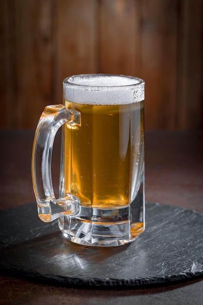 Light beer in a glass on an old background