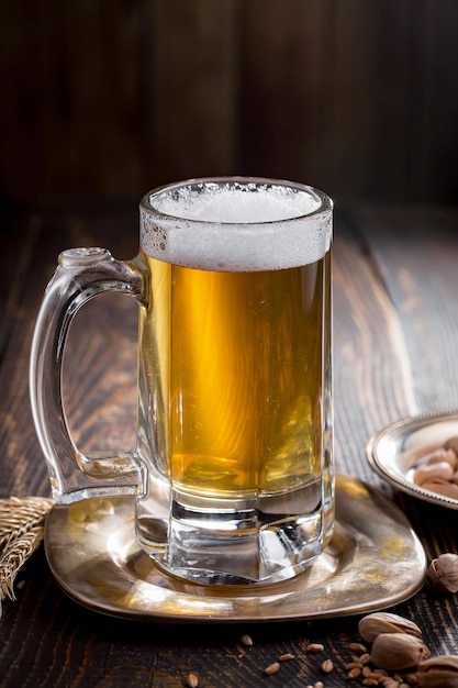 Light beer in a glass on an old background