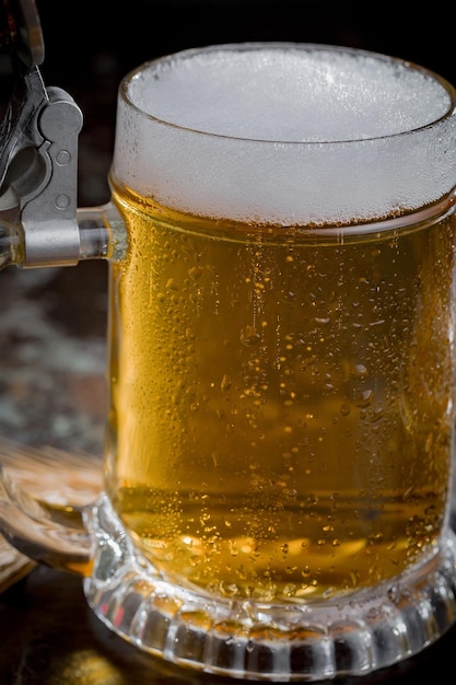 Light beer in a glass on an old background