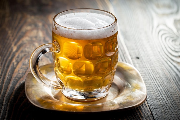 Light beer in a glass on an old background