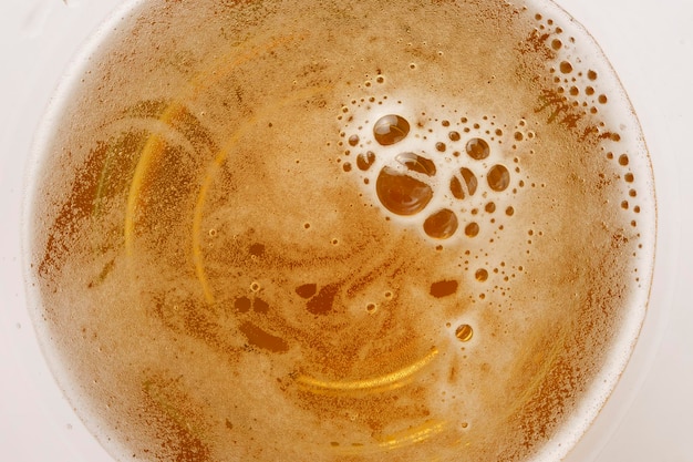 Light beer in a glass with foam and bubbles