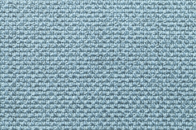 Light blue textile background, closeup. Structure of the fabric macro.