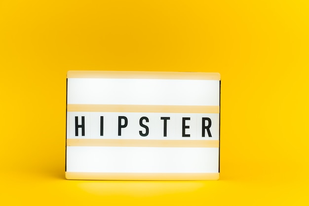 light box with text, HIPSTER, on yellow wall