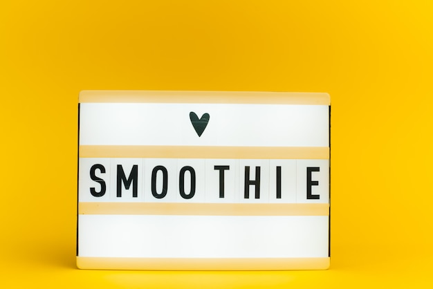 light box with text, SMOOTHIE, on yellow wall