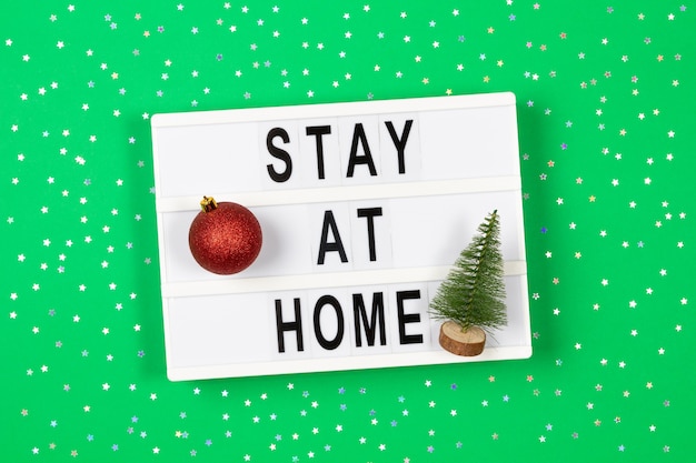 Light box with text stay at home and Christmas decoration