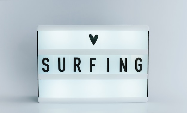 Photo light box with text, surfing on white wall