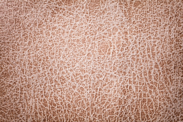 Light brown background from a soft upholstery textile material, closeup