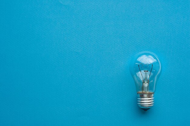 Photo light bulb, blue background, symbol of idea