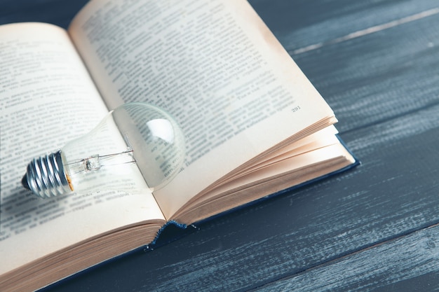 Light bulb and book on the table