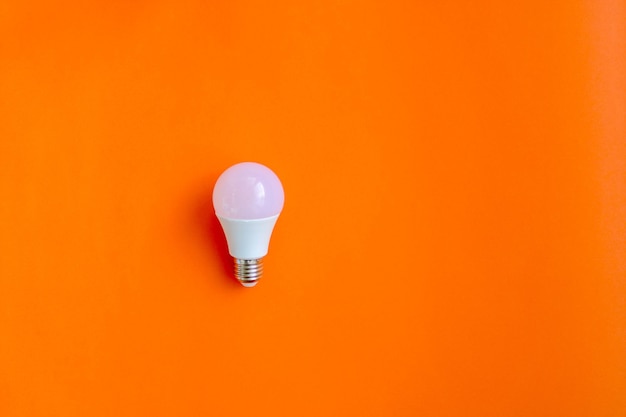 A light bulb on a bright orange background