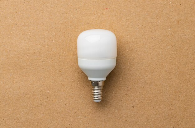 Photo light bulb on craft paper surface close up