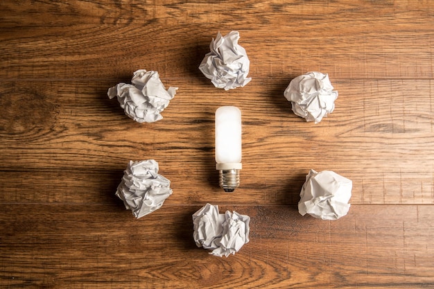 Light bulb and crumpled papers