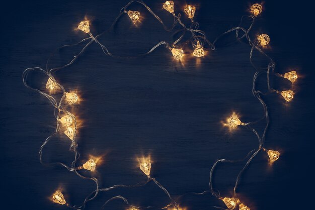 Light bulb garland on wooden dark christmas decoration 