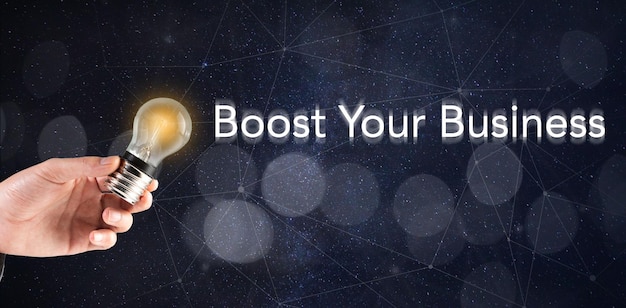 Photo light bulb in hand and boost your business