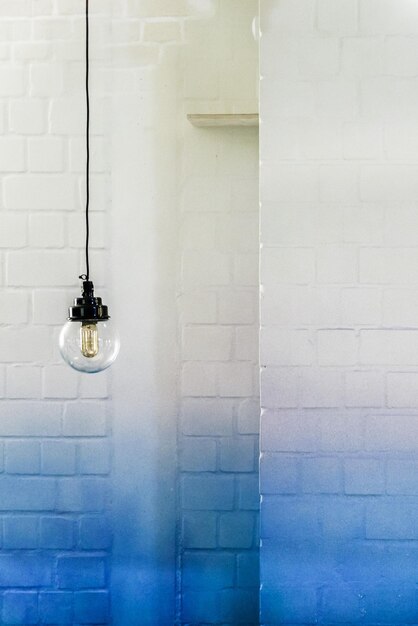 Photo light bulb hanging against wall