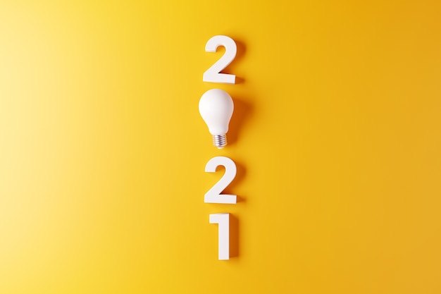 Light bulb idea with 2021 new year yellow background.