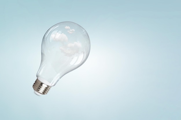 Light bulb on light blue background