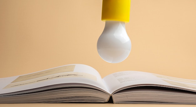 Photo a light bulb over an open book