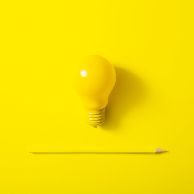 Photo light bulb and sharp pencil on yellow background