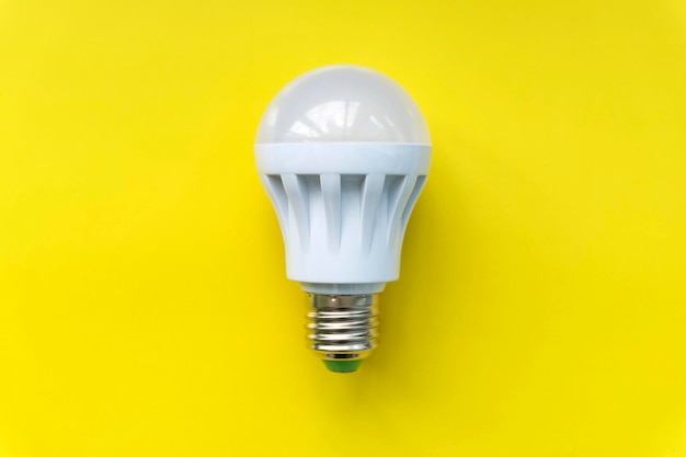 Light bulb on yellow background Fluorescent energy savings led lamp