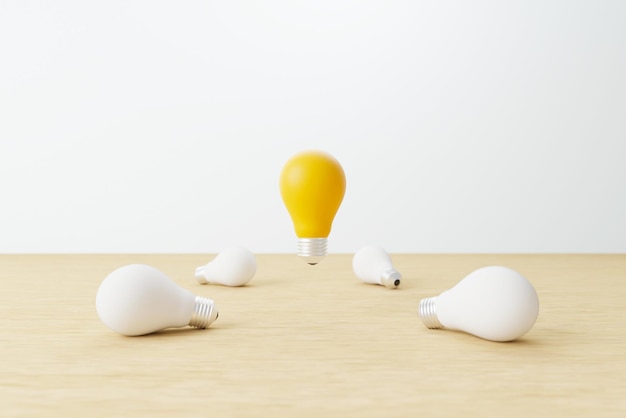 Light bulb yellow floating outstanding among white lightbulb on wood table