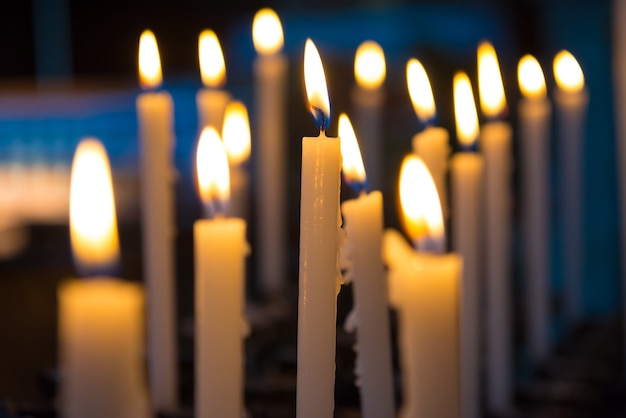 Light of candels in the church on the black background