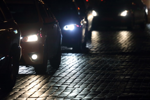 Light cars go at night on the pavement