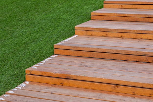 Light color wooden steps near green lawn outside