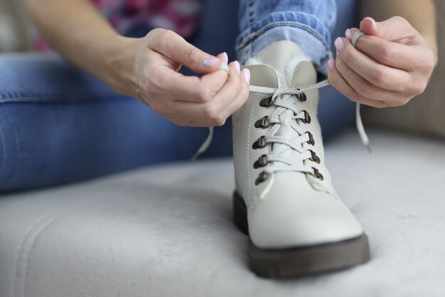 Light colored shoe on which lace is tied.