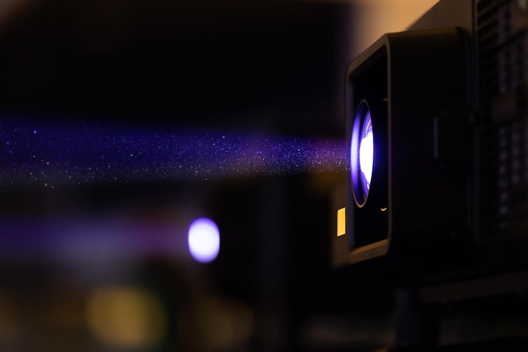 Photo light coming from the cinema spotlight broadcasting the presentation
