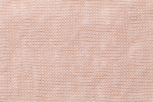 Light coral background closeup. Structure of the fabric macro