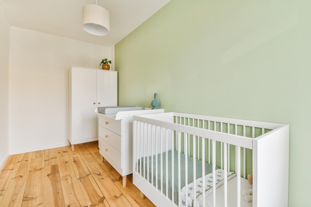 Light cozy baby room with cot